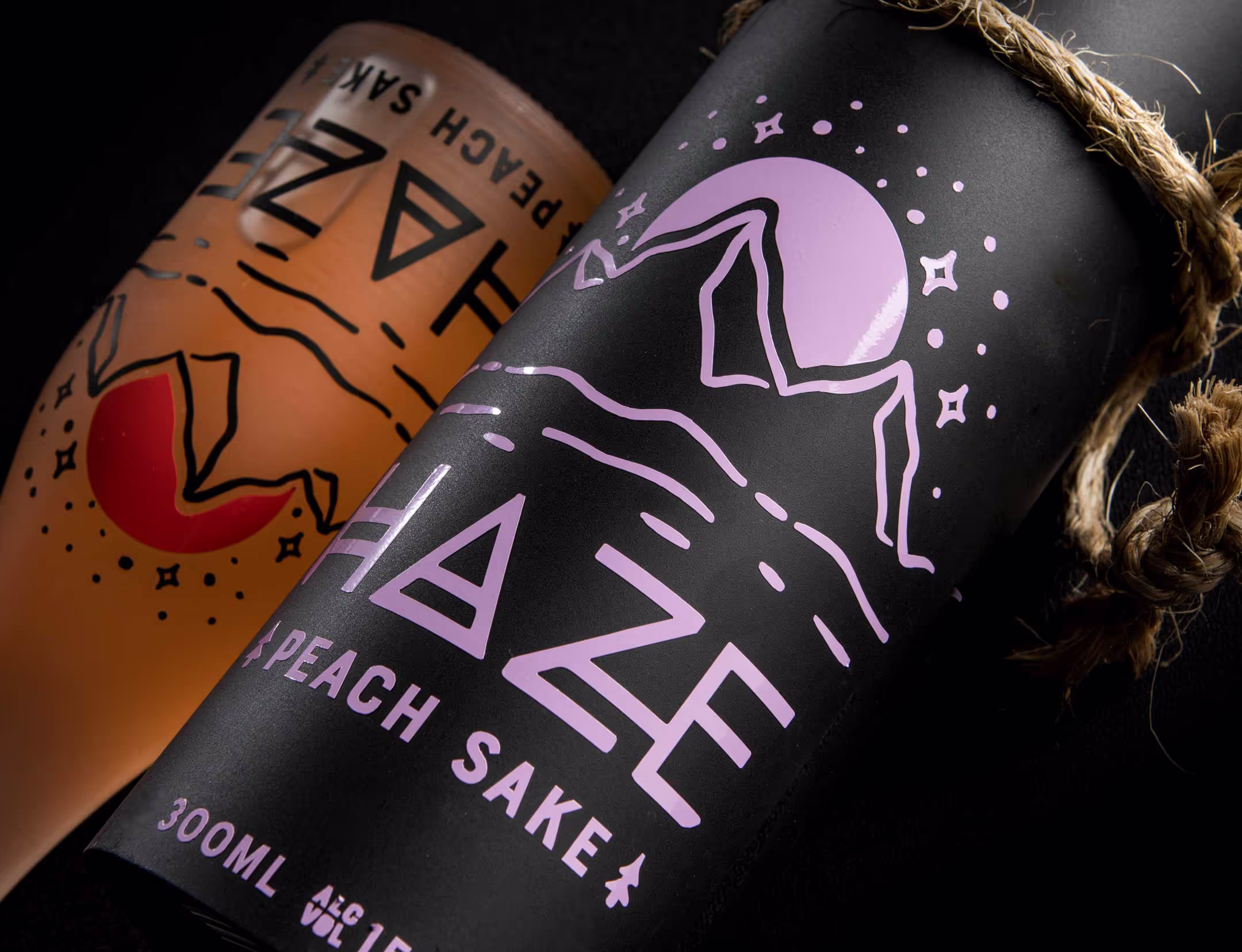 A close-up look at the peach sake variation of the Haze Sake set, showcasing the detailed vinyl labeling, vibrant coloring, and intricate branding.