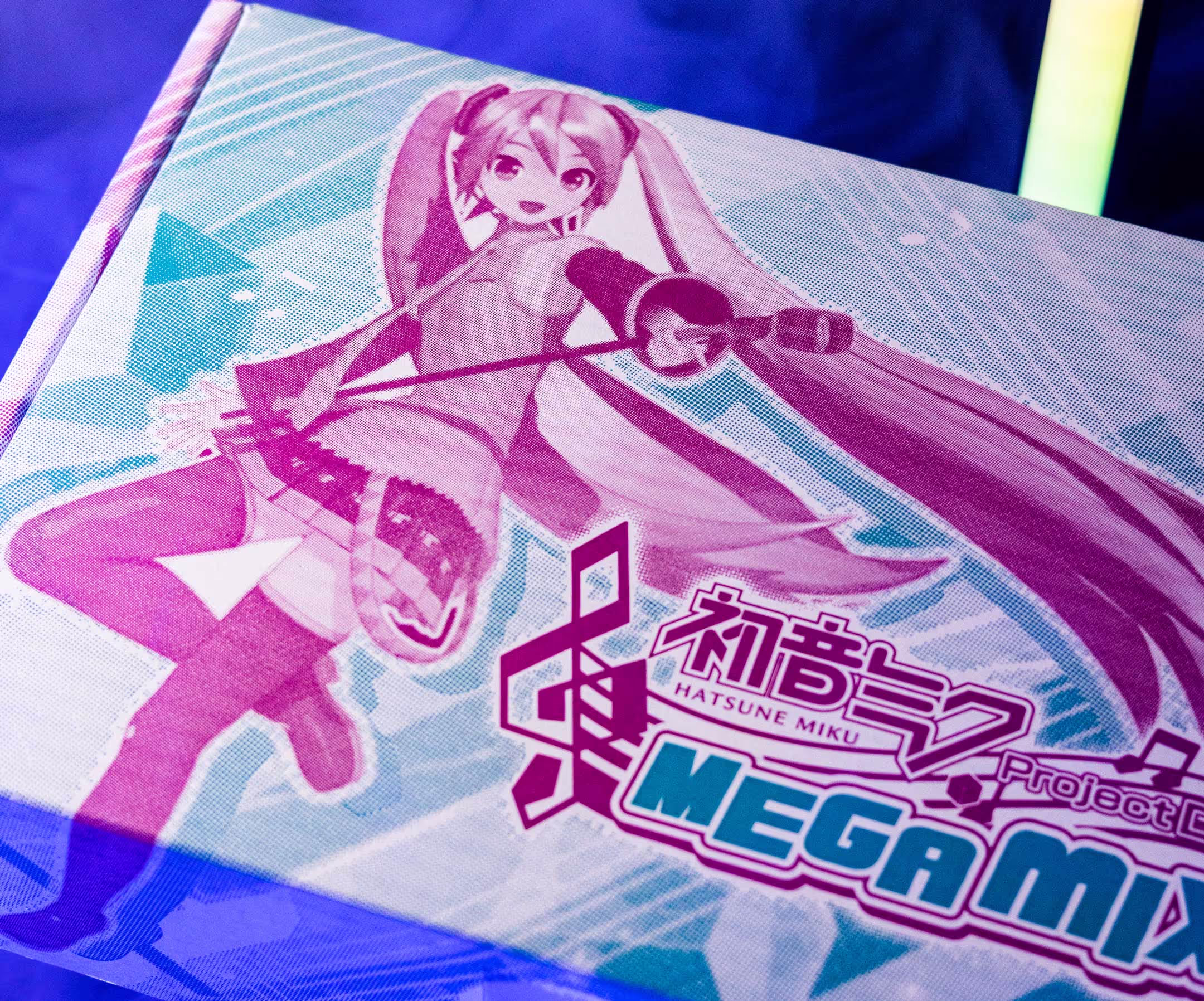A package featuring bright and vivid art and branding from Miku Hatsune - Megamix, the video game published by Sega.